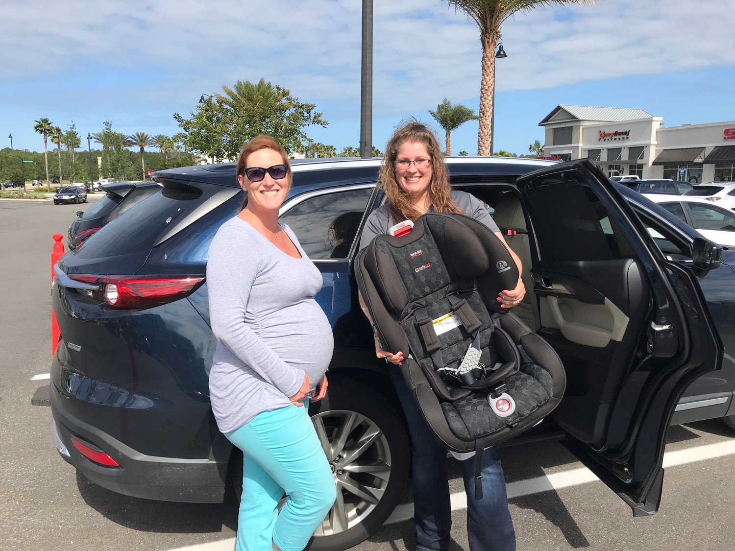 Nocatee resident Kristen Paige and St. Johns County Tax Collector Office employee Vanessa Suarez pose for a photo at the May 2 car seat safety check hosted by REMAX Unlimited.